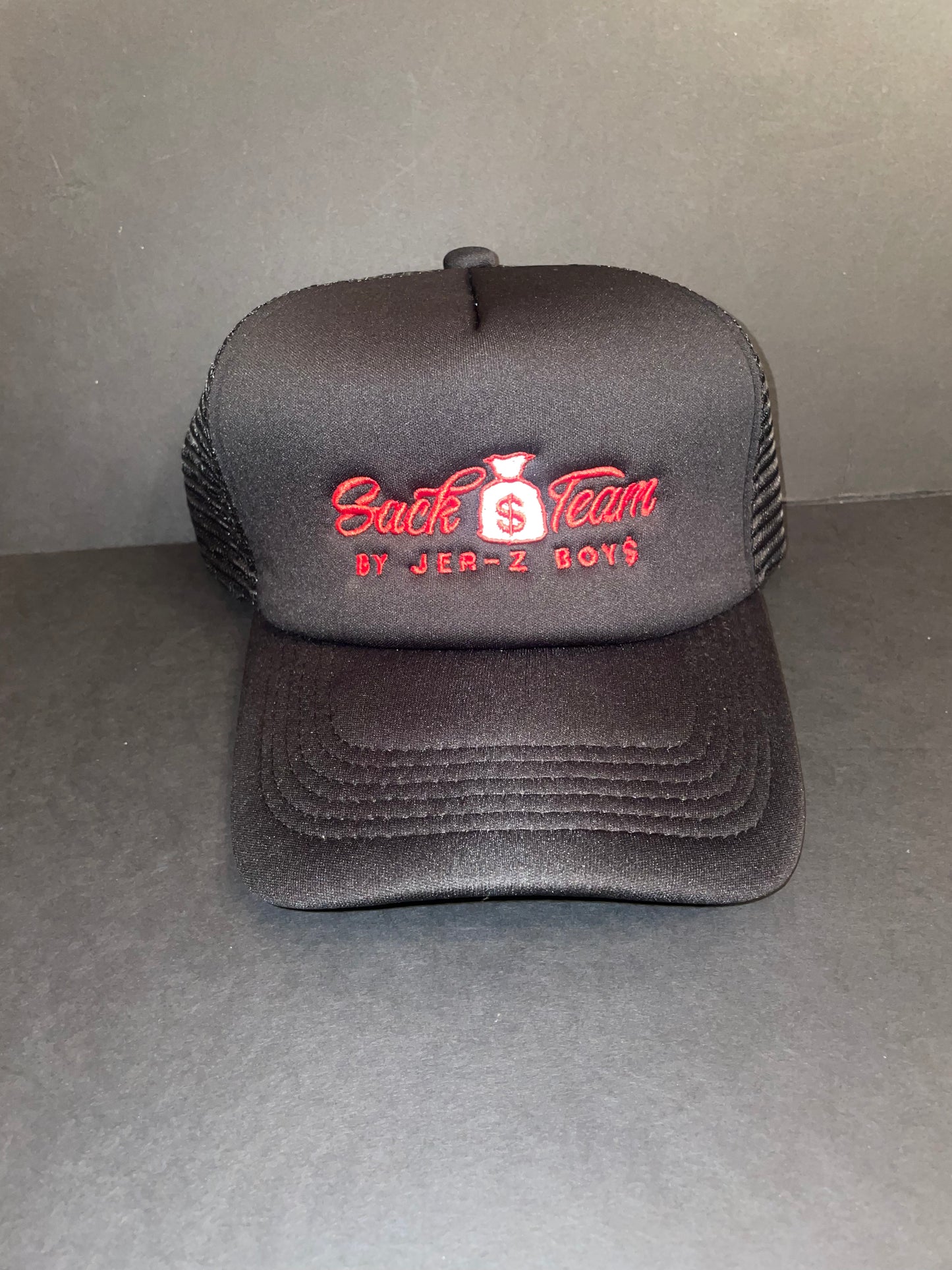 Black trucker hat with red embroidered logo