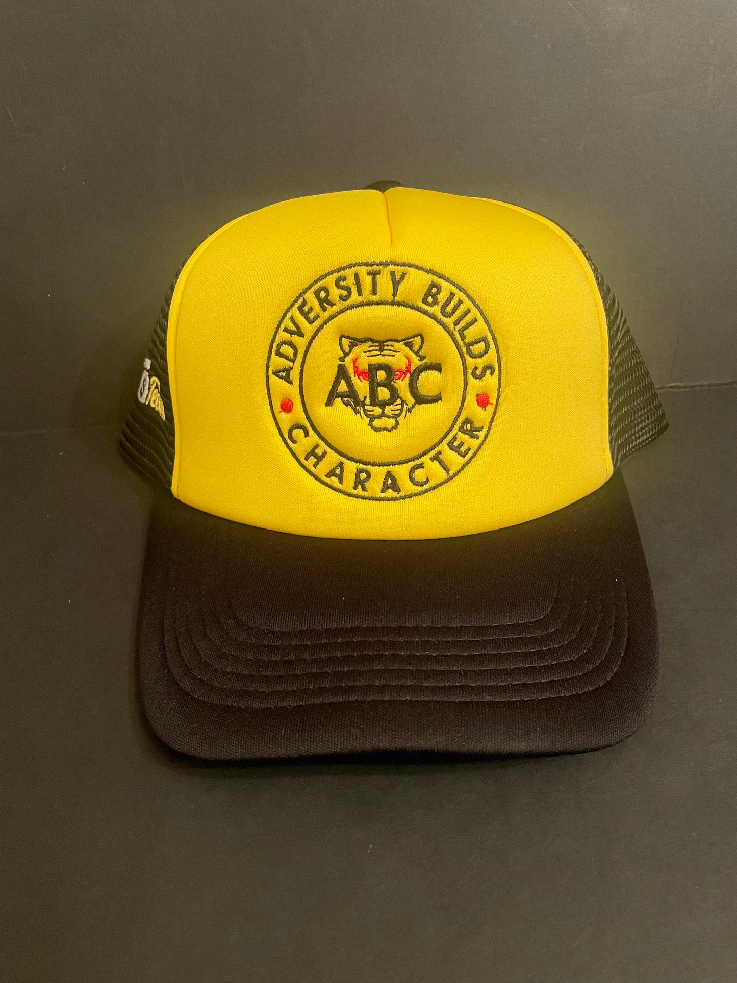 ABC/Sack Team Black/Athletic gold trucker hat